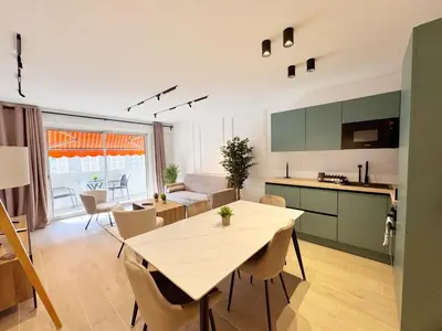 a kitchen and living room with a table and chairs at RF112 - T3 Lumineux à deux pas du port in Nice