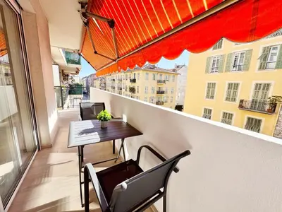 a balcony with a table and chairs on a building at RF112 - T3 Lumineux à deux pas du port in Nice