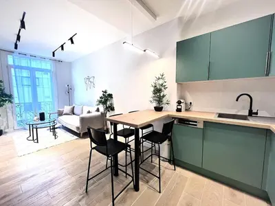 a kitchen and living room with a table and chairs at RF101- Magnifique 3 pièces centre Nice in Nice