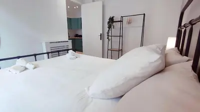 a bedroom with two beds with white sheets and pillows at RF101- Magnifique 3 pièces centre Nice in Nice