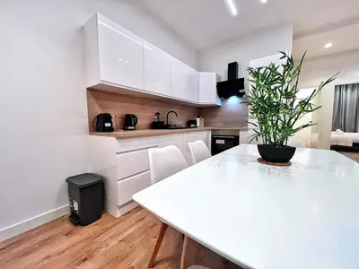 a kitchen with a white table with a potted plant at RF102 - Magnifique et spacieux 3 pièces in Nice