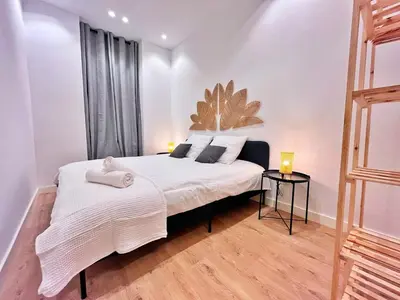 a bedroom with a large white bed and a window at RF102 - Magnifique et spacieux 3 pièces in Nice