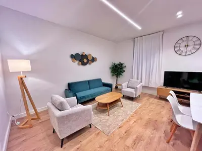 a living room with a blue couch and chairs at RF102 - Magnifique et spacieux 3 pièces in Nice