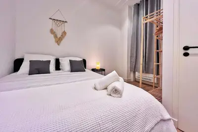 a bedroom with a white bed with a towel on it at RF102 - Magnifique et spacieux 3 pièces in Nice