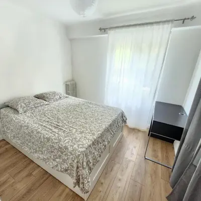 a white bedroom with a bed and a window at Charmant appartement au calme à proximité du Port, de la vieille ville de Nice , de la Promenade des Anglais in Nice
