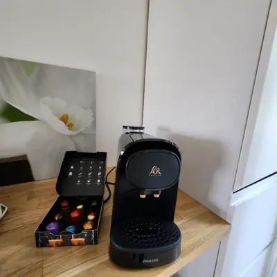 a black blender sitting on a counter with a box of chocolates at Charmant appartement au calme à proximité du Port, de la vieille ville de Nice , de la Promenade des Anglais in Nice