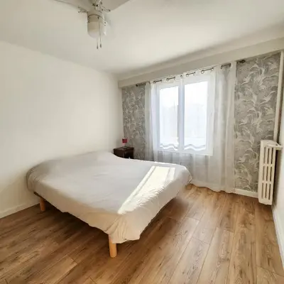 a bedroom with a large bed and a window at Charmant appartement au calme à proximité du Port, de la vieille ville de Nice , de la Promenade des Anglais in Nice