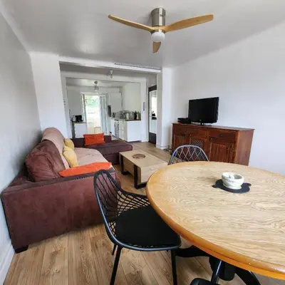 a living room with a couch and a table at Charmant appartement au calme à proximité du Port, de la vieille ville de Nice , de la Promenade des Anglais in Nice