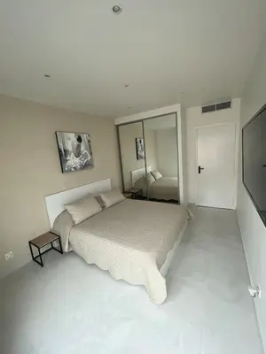 a bedroom with a large bed and a television at Sea view apartment in Cagnes-sur-Mer