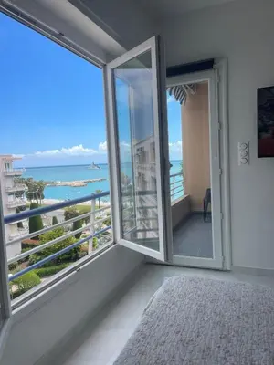 a bedroom with a view of the ocean at Sea view apartment in Cagnes-sur-Mer
