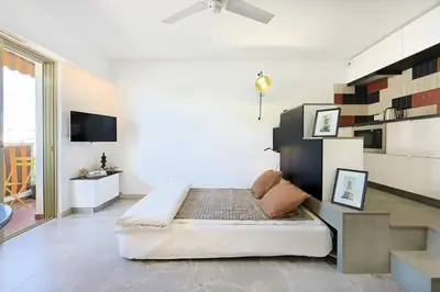 a bedroom with a bed and a table and chairs at OFF