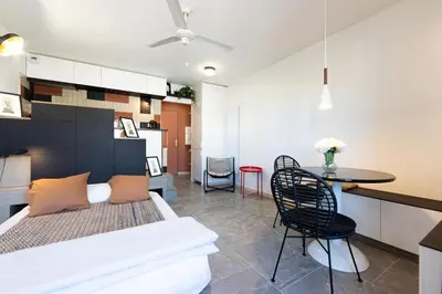 a bedroom with a bed and a table and chairs at OFF