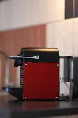 a black and red toaster sitting on a counter at OFF