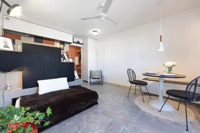 a bedroom with a bed and a table and chairs at OFF