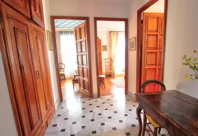 a room with a table and a hallway with doors at Villa La Rara Beaulieu Centre in Beaulieu-sur-Mer