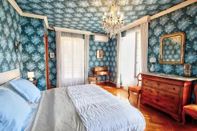a bedroom with a bed and a dresser and a mirror at Villa La Rara Beaulieu Centre in Beaulieu-sur-Mer