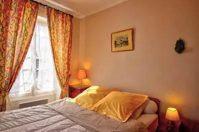 a bedroom with a bed and a window at Villa La Rara Beaulieu Centre in Beaulieu-sur-Mer