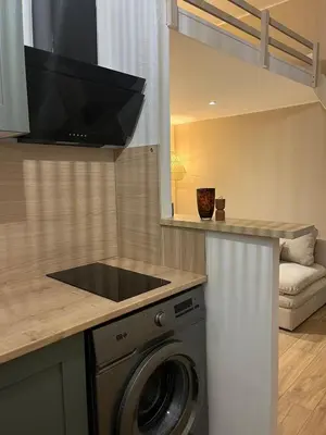 a kitchen with a washing machine in a kitchen at Studio confort proche du port in Nice