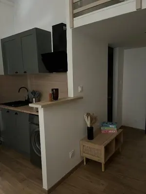 a kitchen with a sink and a table in a room at Studio confort proche du port in Nice