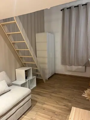 a living room with a staircase and a couch at Studio confort proche du port in Nice