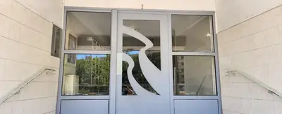 a glass door of a building with a sculpture on it at AERO Nice in Nice