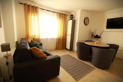 a living room with a couch and a table at AERO Nice in Nice
