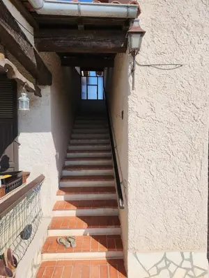 a staircase leading up to a building with a stair case at Superbe appartement vue mer in Cagnes-sur-Mer