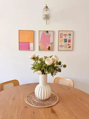 a vase with flowers sitting on a table at Chic & cosy proche mer in Nice