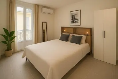 a bedroom with a large white bed and a window at Charmant appartement 3 grandes chambres au coeur de Nice au calme absolu in Nice