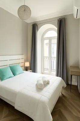 a bedroom with a large white bed with a window at Splendide appartement design plein centre nice climatisé - 3 chambres in Nice