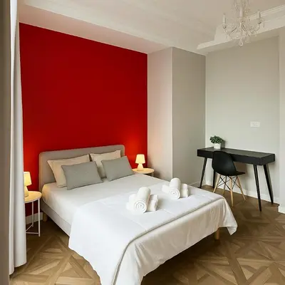 a bedroom with a white bed with a red wall at Splendide appartement design plein centre nice climatisé - 3 chambres in Nice