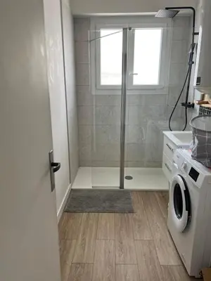 a bathroom with a toilet and aige and gold wallpaper at Charmant T2 proche tramway et plages in Nice