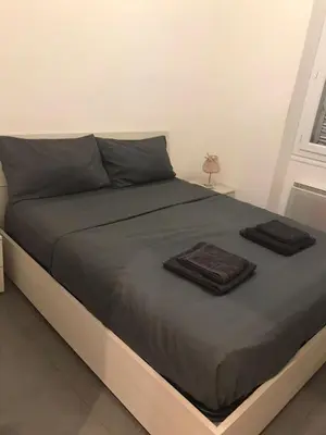 a bed with two towels on it in a bedroom at Appart Le Carré D'Or in Nice