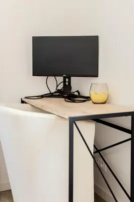 a computer monitor sitting on top of a desk at Nice Magnan, Appartement proches plage et tramway in Nice