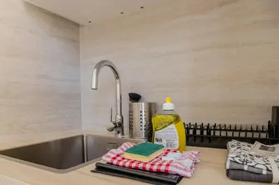 a kitchen counter with a sink and some towels at Nice Magnan, Appartement proches plage et tramway in Nice