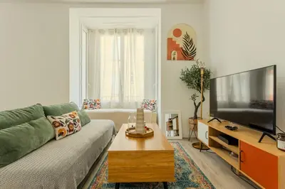 a living room with a couch and a flat screen tv at Nice Magnan, Appartement proches plage et tramway in Nice