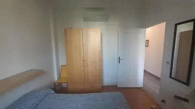 a bedroom with a blue bed and a wooden cabinet at Apartment Palais de Coppet in Nice