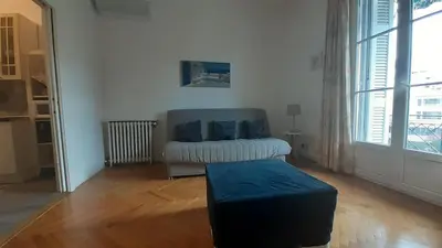 a living room with a couch and a table at Apartment Palais de Coppet in Nice