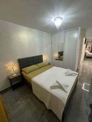 a bedroom with a bed with two towels on it at Appartement Luxe & design Vue mer sur la Promenade des Anglais in Nice
