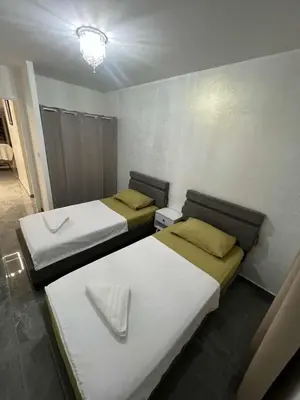 a room with two beds in a room with at Appartement Luxe & design Vue mer sur la Promenade des Anglais in Nice