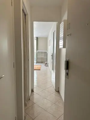 an empty hallway with a dog sitting in the middle of a room at Studio Riviera - balcon et Wifi in Nice