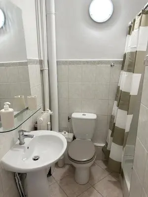 a bathroom with a white toilet and a sink at Studio Riviera - balcon et Wifi in Nice