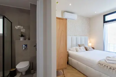 a bedroom with a white bed and a toilet at #52 Etoile Suite ,Central, Balcony, AC-5 min P Massena in Nice