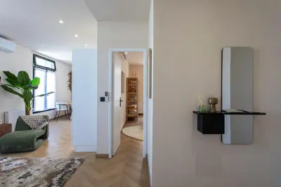 a living room with a white wall and a refrigerator at #52 Etoile Suite ,Central, Balcony, AC-5 min P Massena in Nice