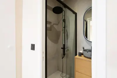 a bathroom with a shower with a sink and a mirror at #52 Etoile Suite ,Central, Balcony, AC-5 min P Massena in Nice