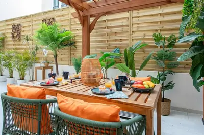 a wooden table with food on it on a patio at #55 Sun terrace AC & Wifi 10mins walk to Sea & oldtown in Nice