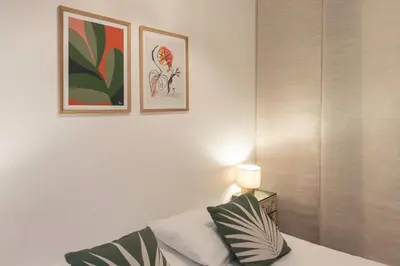 a bedroom with a bed and two pictures on the wall at #55 Sun terrace AC & Wifi 10mins walk to Sea & oldtown in Nice