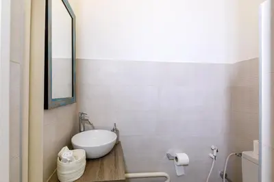 a bathroom with a white sink and a mirror at Palais D'orient in Nice