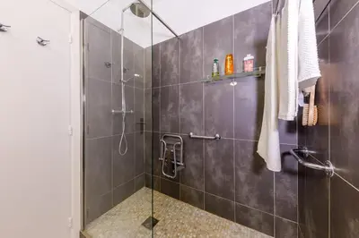 a bathroom with a shower with a glass door at Palais D'orient in Nice