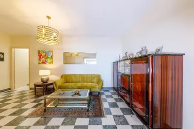 a living room with a couch and a table at Palais D'orient in Nice
